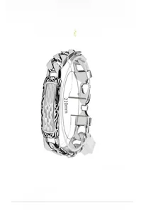 Detail of masculine titanium steel bracelet featuring a handcrafted hammered textured plate