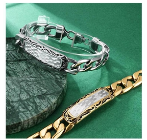 Detail of men's stainless steel curb bracelet with vintage patterned rectangular plate
