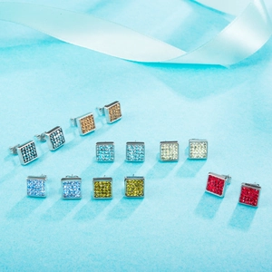 Square stainless steel stud earrings set with colorful pavé rhinestones on blue background