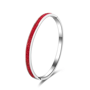 Sleek silver stainless steel bangle featuring three rows of inset red crystals