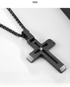 Vue macro du pendentif croix en acier inoxydable noir brossé avec pierre de zircone centrale