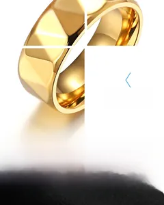 Detail of golden stainless steel ring with geometric faceted diamond-cut texture