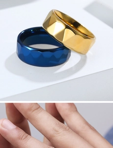 Macro view of geometric faceted stainless steel rings in gold and deep blue finish