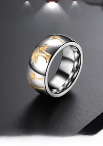 Detail showing polished silver steel ring with gold etched palm tree patterns