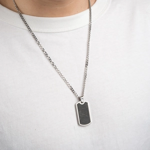 Men's rectangular carbon fiber pendant on a silver curb chain necklace shown on model