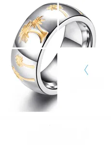 Macro view of two-tone stainless steel ring with golden palm tree relief detailing