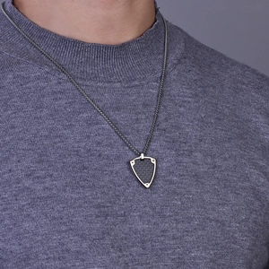 Men's shield pendant necklace with black carbon fiber texture and rivet details on chain