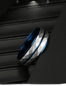 Detail view of faceted silver steel ring with a contrasting deep blue inner band coating