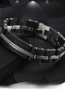 Détail d'un bracelet pour homme en acier inoxydable avec fibre de carbone et clous polis