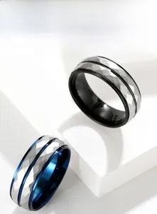 Detail of men's faceted stainless steel rings with blue and black inner plating and silver band