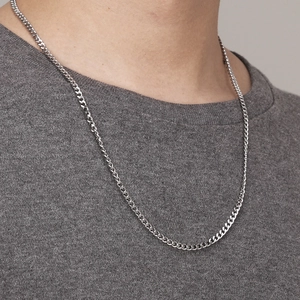 Polished silver stainless steel curb chain necklace worn on neck for a minimalist unisex look
