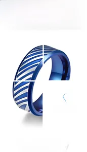 Detailed view of silver and blue two-tone stainless steel ring with slanted stripe texture
