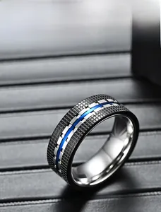 Macro detail of men's black checkered titanium ring with a vibrant blue inlay groove