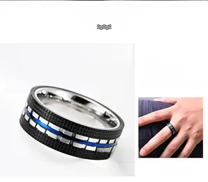 Detail of blue and black dual-tone stainless steel ring with polished finish and mesh pattern