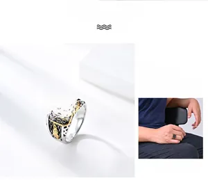 Detail of men's two-tone ring with black stone micro-pave and golden feather carving