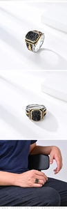 Detail of vintage men's ring featuring black square gemstone and side hollow carvings