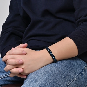 Men's stainless steel chain bracelet in black and blue dual-tone finish on wrist