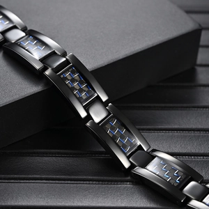 Men's titanium magnetic bracelet with black carbon fiber and blue accents in a gift box