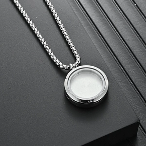 Polished silver stainless steel floating locket necklace with glass panels on a box chain