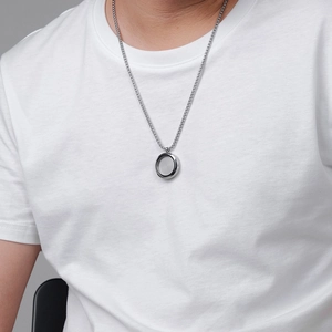 Silver stainless steel long chain necklace with a hollow round pocket watch pendant on a model