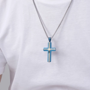 Religious stainless steel two-tone cross pendant necklace worn by male model on white shirt