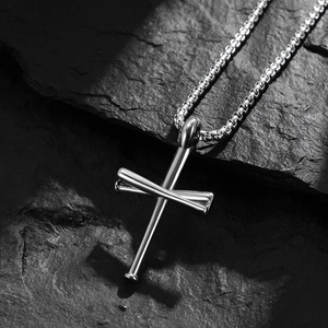Polished stainless steel baseball cross necklace for men on black stone background