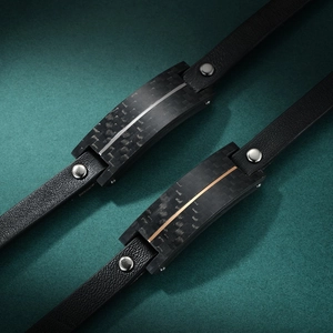 Men's minimalist black leather bracelet with carbon fiber inlay in silver and gold tones