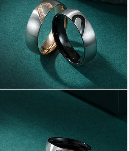 Close-up of interlocking heart-shaped titanium steel couple rings with brushed finish