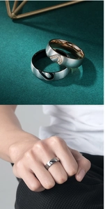 Detail of brushed titanium steel couple rings forming a heart shape with zircon inlay