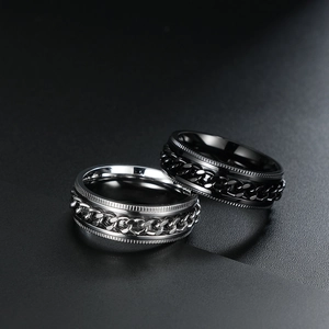 Set of silver and black stainless steel spinner rings featuring rotating Cuban chains