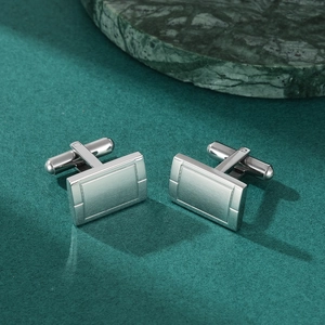 Silver rectangular stainless steel cufflinks with brushed finish on green marble