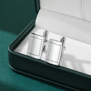 Polished silver rectangular stainless steel cufflinks with T-link in a green jewelry box