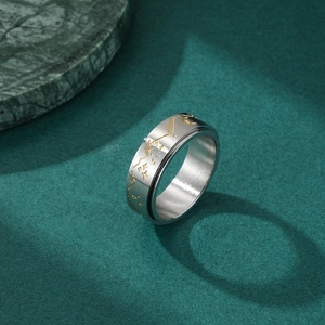 Stainless steel spinning ring featuring gold moon and star engravings for stress relief