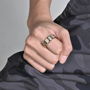 Men's two-tone stainless steel wide ring with engraved flame patterns on finger