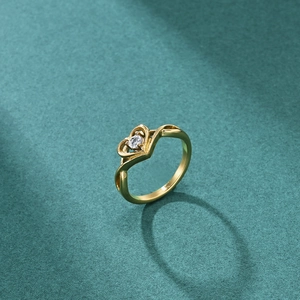 Elegant 18K gold-plated heart ring with sparkling round zircon on a dark green background