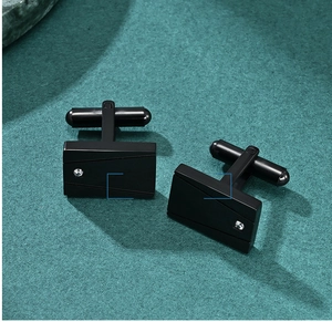 Close-up of black square stainless steel cufflinks with CNC diagonal lines and stones