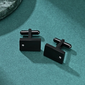 Square black plated stainless steel cufflinks with geometric lines and a small crystal stone