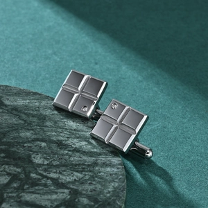 Silver square stainless steel cufflinks with grid engraving and crystal on marble base