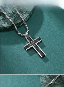 Detailed macro view of a silver stainless steel cross pendant with black honeycomb texture