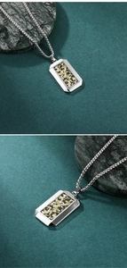 Detail of hexagonal stainless steel pendant with green camo inlay on round link chain