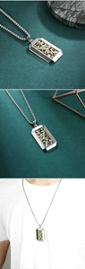 Close-up of men's hexagonal camo military pendant with silver chain and green epoxy detail