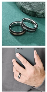 Detail of men's matte and polished two-tone steel rings showing textured finish