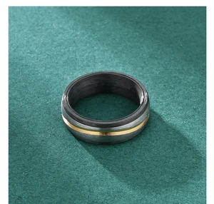 Macro detail of men's titanium ring with carbon fiber interior and gold inlay line
