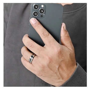 Close-up of a minimalist titanium steel ring for men with black inlay worn on a hand