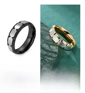 Detail view of V-groove couple rings in brushed black, gold and silver stainless steel