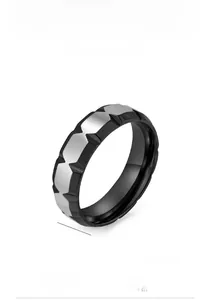 Macro detail of a 7mm titanium steel ring featuring black and silver geometric V-groove
