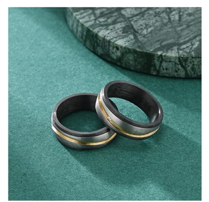Macro detail of carbon fiber inlay and brushed titanium ring with sparkling stone setting