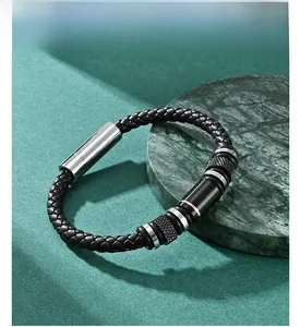 Detailed close-up of a woven black leather bracelet with dual-tone metal buckle detail
