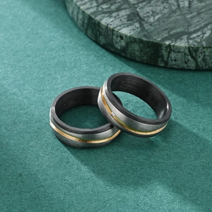 Carbon fiber and brushed titanium ring set with gold stripe and small zircon stone