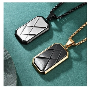 Close-up of geometric faceted military tag pendants with brushed steel texture